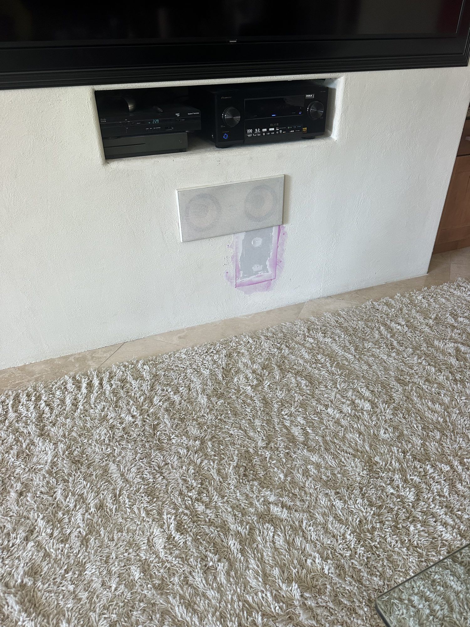 In-wall speaker installed with the wall patched and painted
