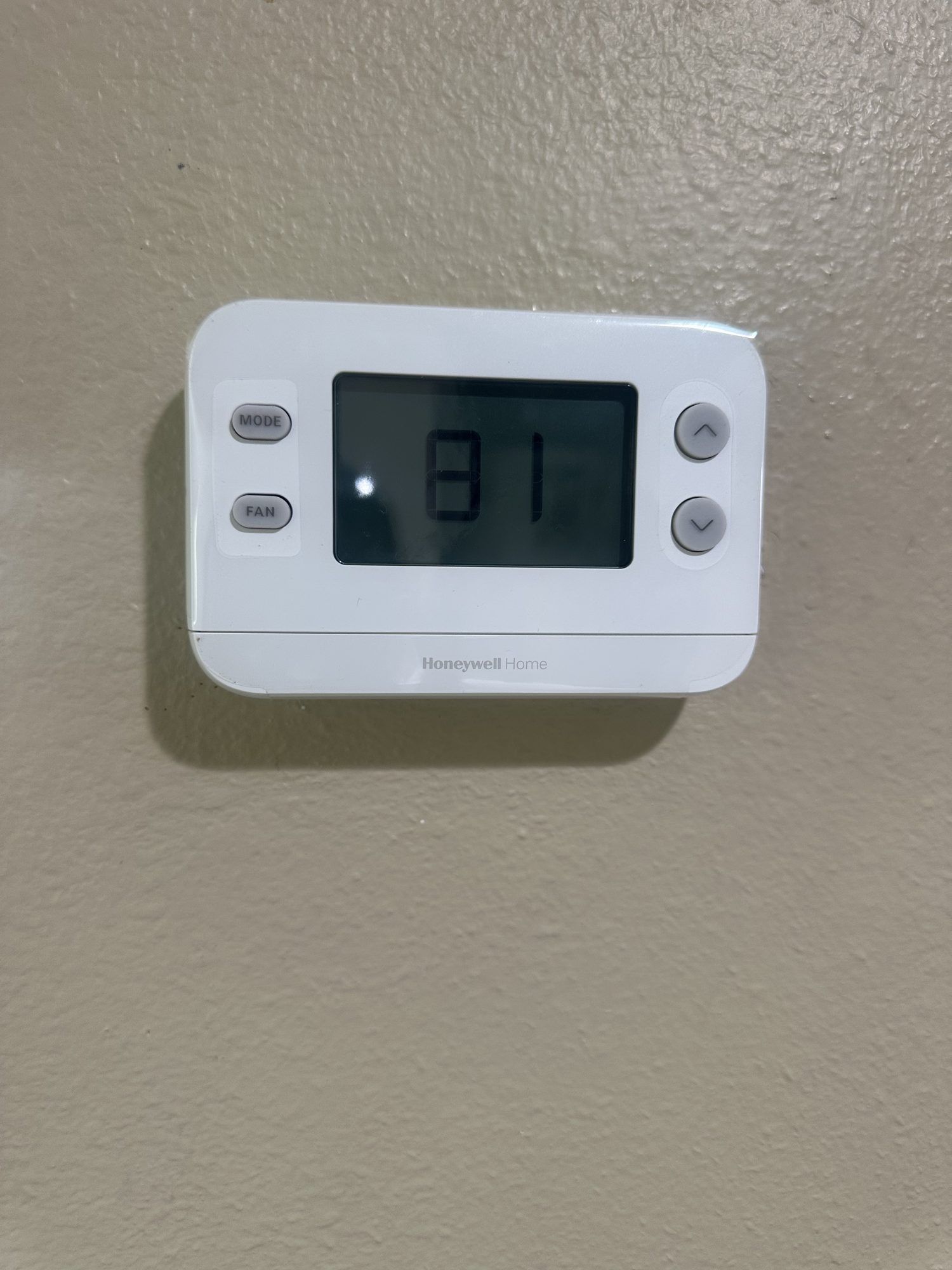 Honeywell digital thermostat installed on a wall