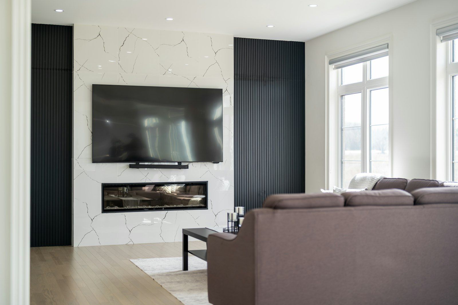 TV mounted on the wall above a fireplace